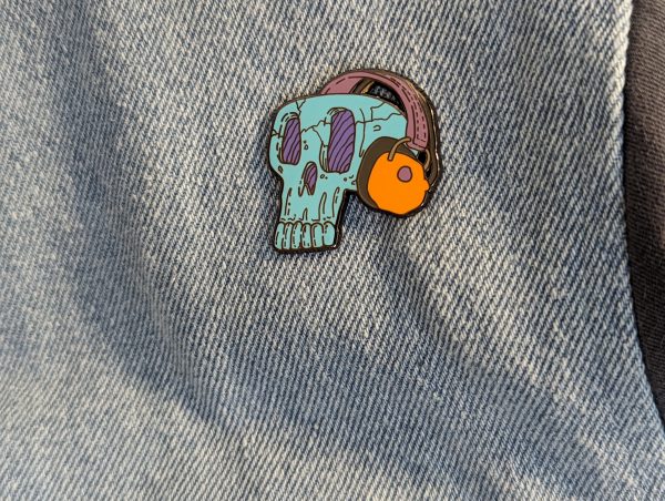 Blue Headphone Skull enamel pin fitted to denim